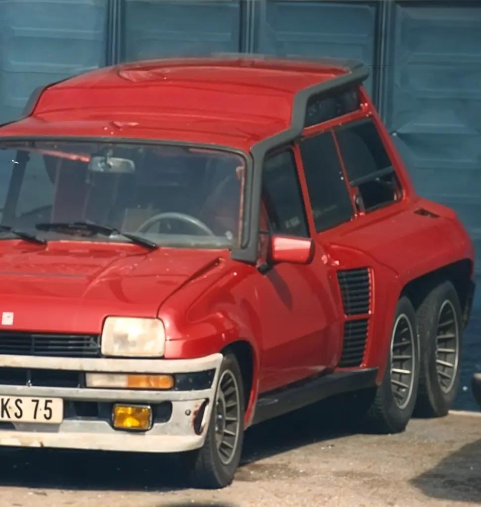 Close-up front and side view of the Renault 5 Turbo 6x6, showcasing its wide body kit and distinctive triple-axle configuration