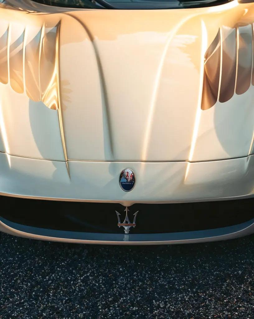 Detailed shot of the Maserati MC12’s engine cover with aerodynamic vents, emphasizing its performance engineering
