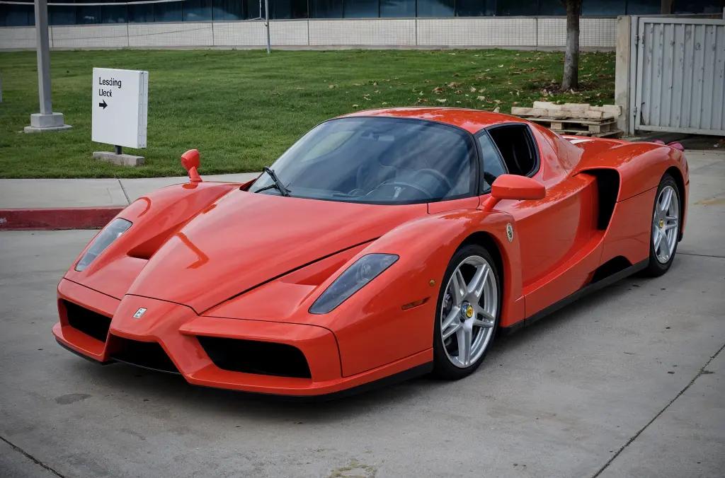 Ferrari Enzo in iconic red, emphasizing its sleek design and Formula 1 heritage