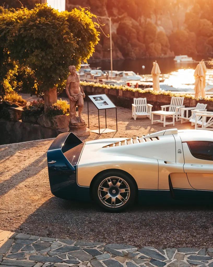 Rear-quarter view of the Maserati MC12 with its distinctive rear wing and carbon-fiber body, captured in golden-hour lighting