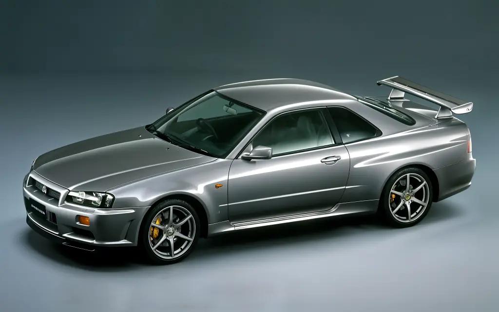 "Nissan Skyline GT-R R34 V-Spec with an iconic rear wing, standing out in metallic blue