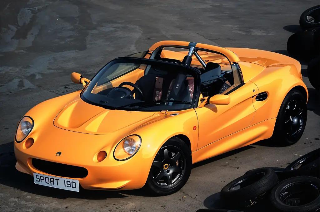 Lotus Elise S1 in bright yellow, a lightweight 1990s roadster.