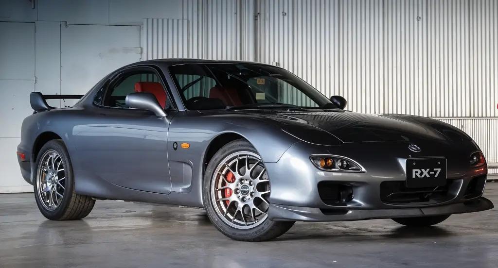 Mazda RX-7 Spirit R in gray, with pop-up headlights and a sporty stanc